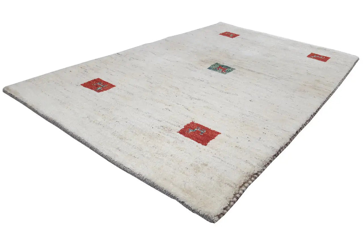 Gabbeh rug in cream with several red squares and a turquoise motif
