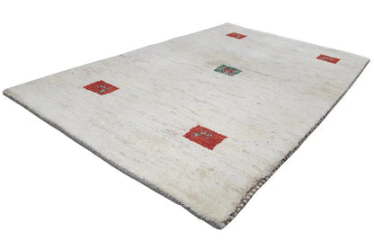 Gabbeh rug in cream with several red squares and a turquoise motif