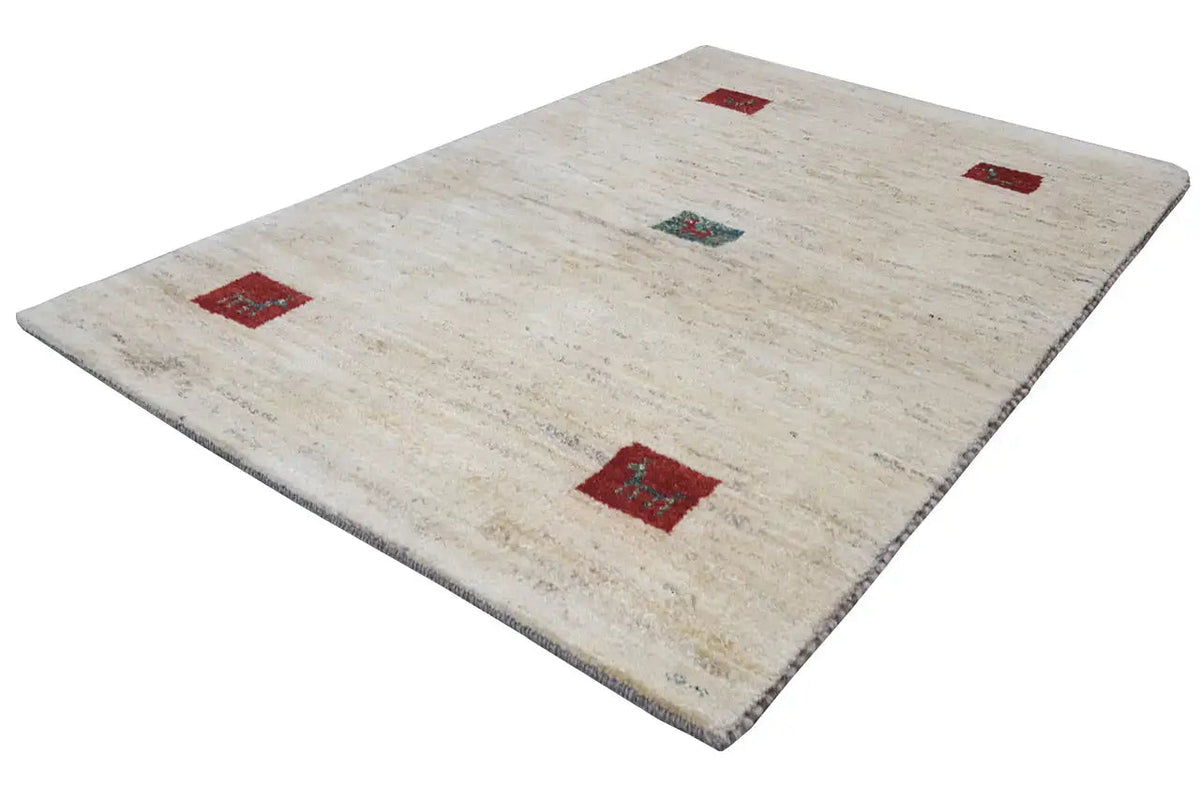 Gabbeh rug in cream with red square motifs and a turquoise central pattern