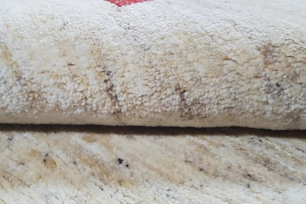 Gabbeh rug: close-up of the dense cream pile with a subtle texture
