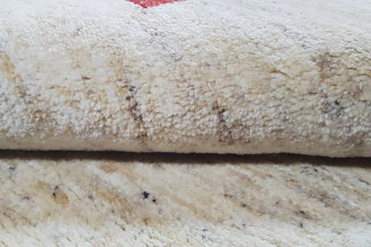 Gabbeh rug: close-up of the dense cream pile with a subtle texture
