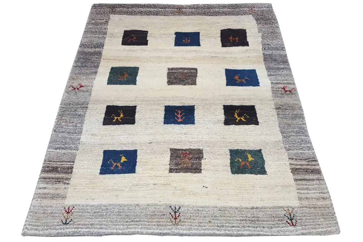 Gabbeh rug: cream-colored background, gray border, colorful squares in a grid