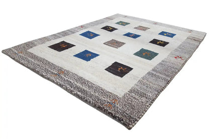 Gabbeh rug, shown at an angle: cream-colored background, gray border, square pattern