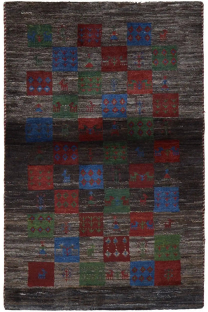 Gabbeh rug with patchwork pattern in dark gray, red, blue, and green