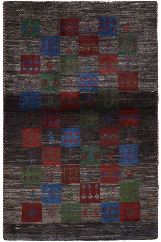 Gabbeh rug with patchwork pattern in dark gray, red, blue, and green
