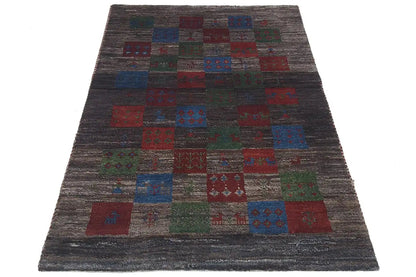 Gabbeh rug, dark geometric pattern made of colorful squares in red, blue, and green