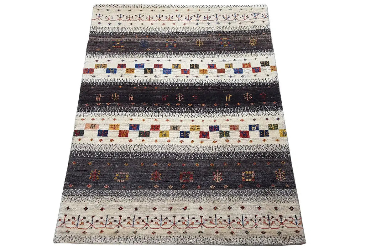 Rug in three-quarter view with a striped and diamond pattern, light beige, dark, colorful