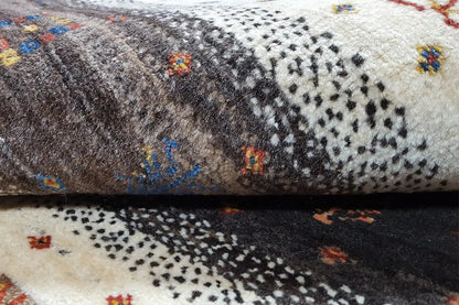 Carpet detail with dense pile and colorful ornaments in a dark striped area