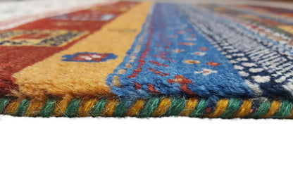 Gabbeh rug close-up: multicolored pile and fringes along the edge