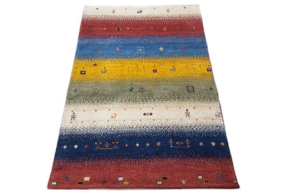 Gabbeh rug with multicolored stripes in red, blue, yellow, and beige accents.
