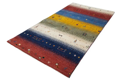 Gabbeh rug, laid flat: striped design in shades of red, blue, and yellow.