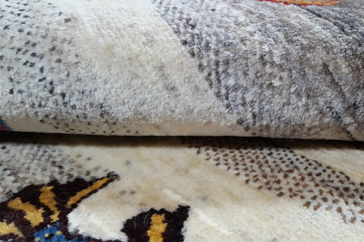 Close-up of the carpet fabric with loop pile and a multicolored animal motif along the edge