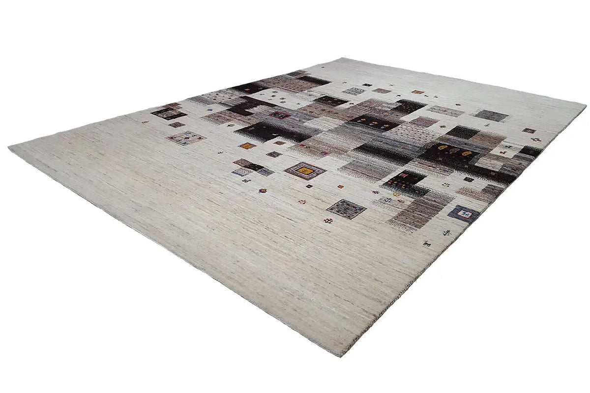 Gabbeh-Lori rug at an oblique angle: patchwork pattern of beige and dark areas