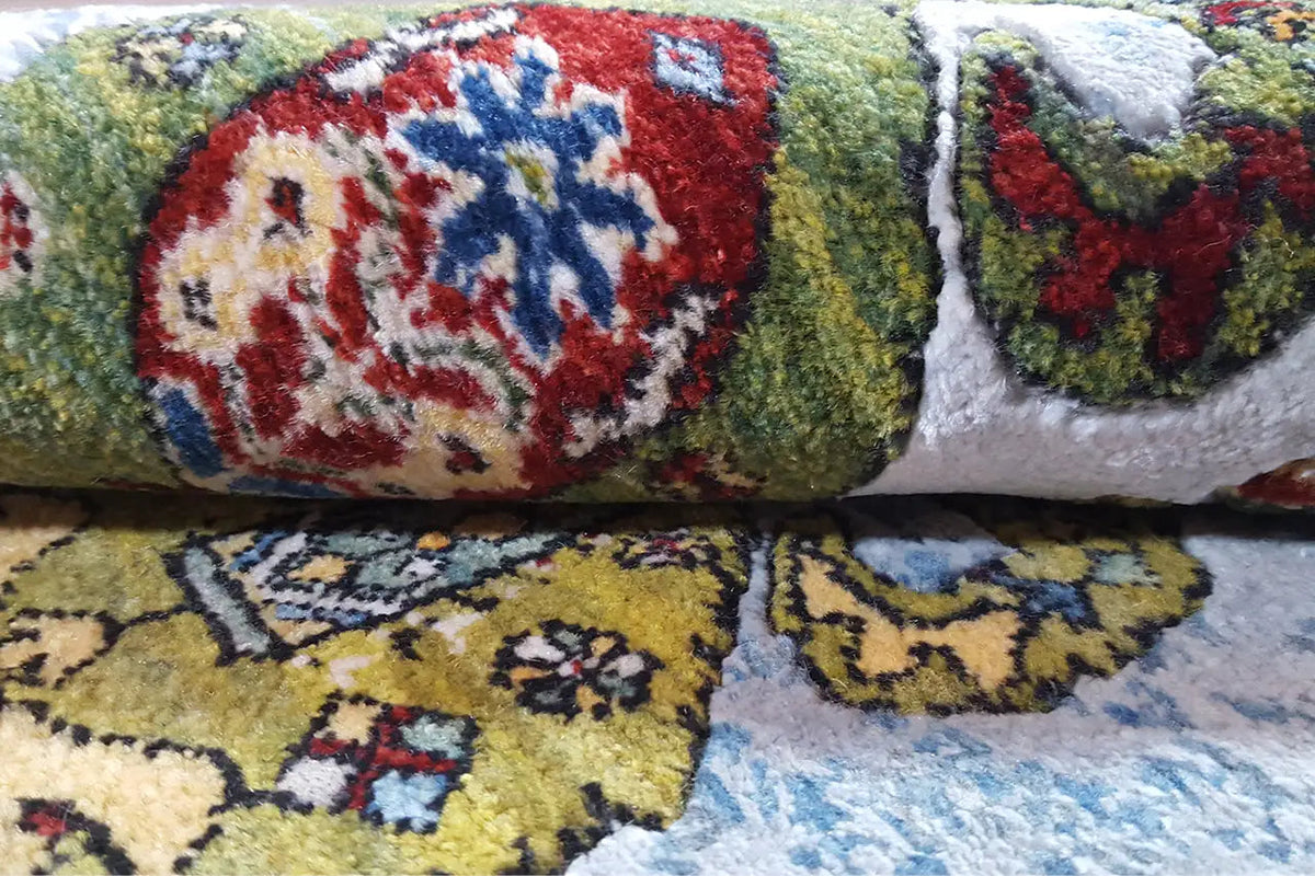 Gabbeh rug, detail of the pile height with colorful patterns on a blue-gray background