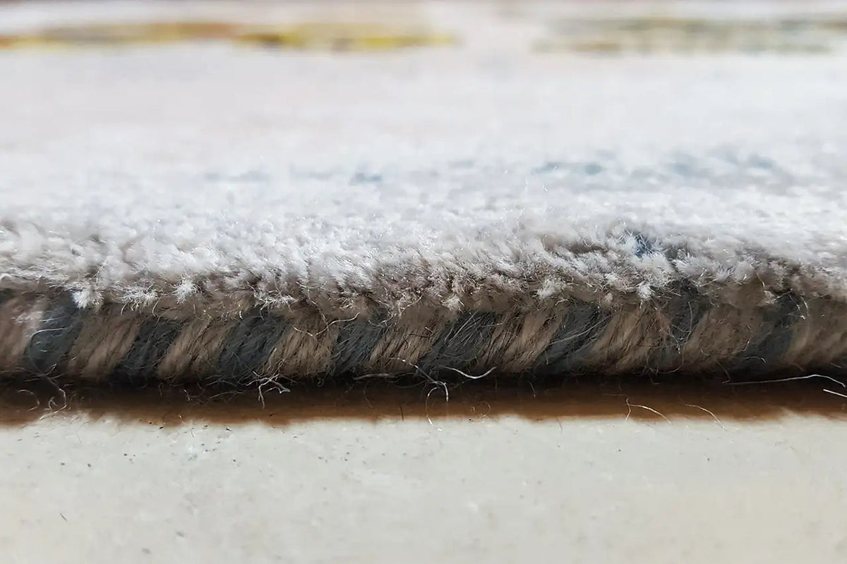 Gabbeh rug edge with a dense pile border and short, thick fringes