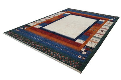 Rectangular Gabbeh rug with multicolored border stripes and a light central medallion.
