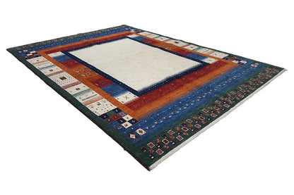 Corner view of a Gabbeh rug with a colorful border, light center, and finished edges.