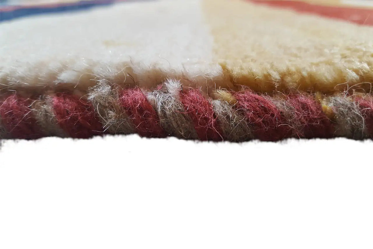 Close-up of the carpet edge: dense pile with a red-beige color transition