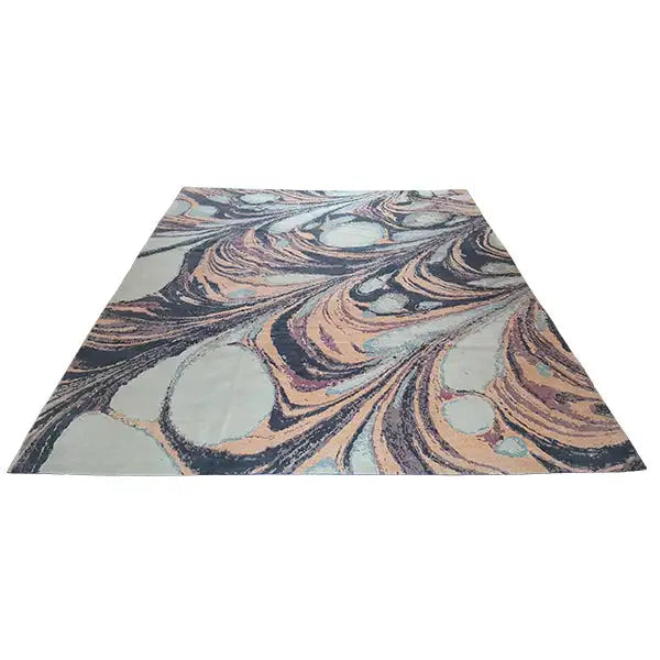 Rug in triangular view with an abstract pattern in shades of blue, gray, and purple
