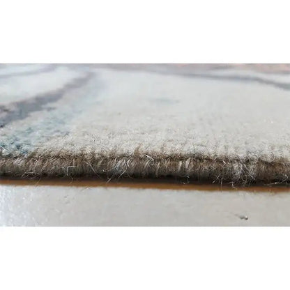 Rug edge with short pile and visible backing, flat and stable