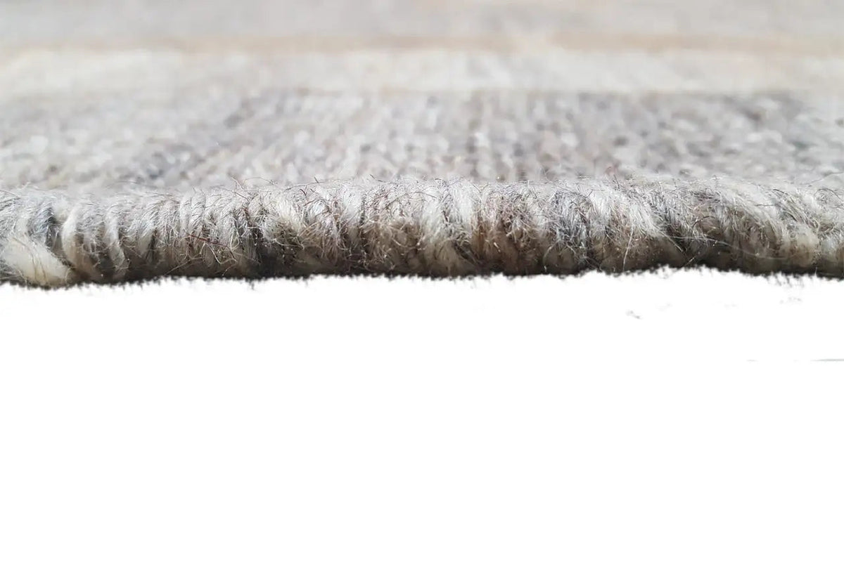Kilim rug with a visible selvedge and dense pile, gray-beige