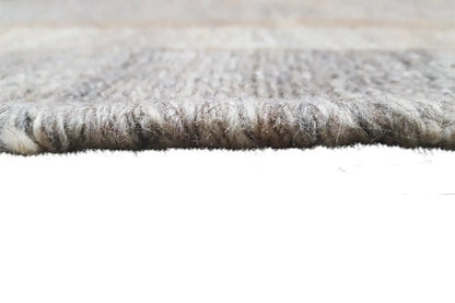 Kilim rug with a visible selvedge and dense pile, gray-beige