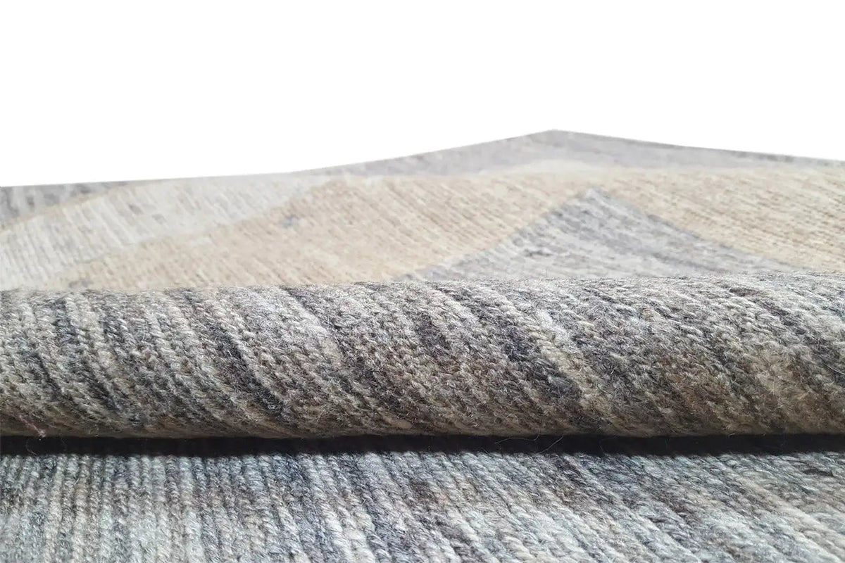 Kilim rug detail: textured pile in light gray with a beige accent stripe