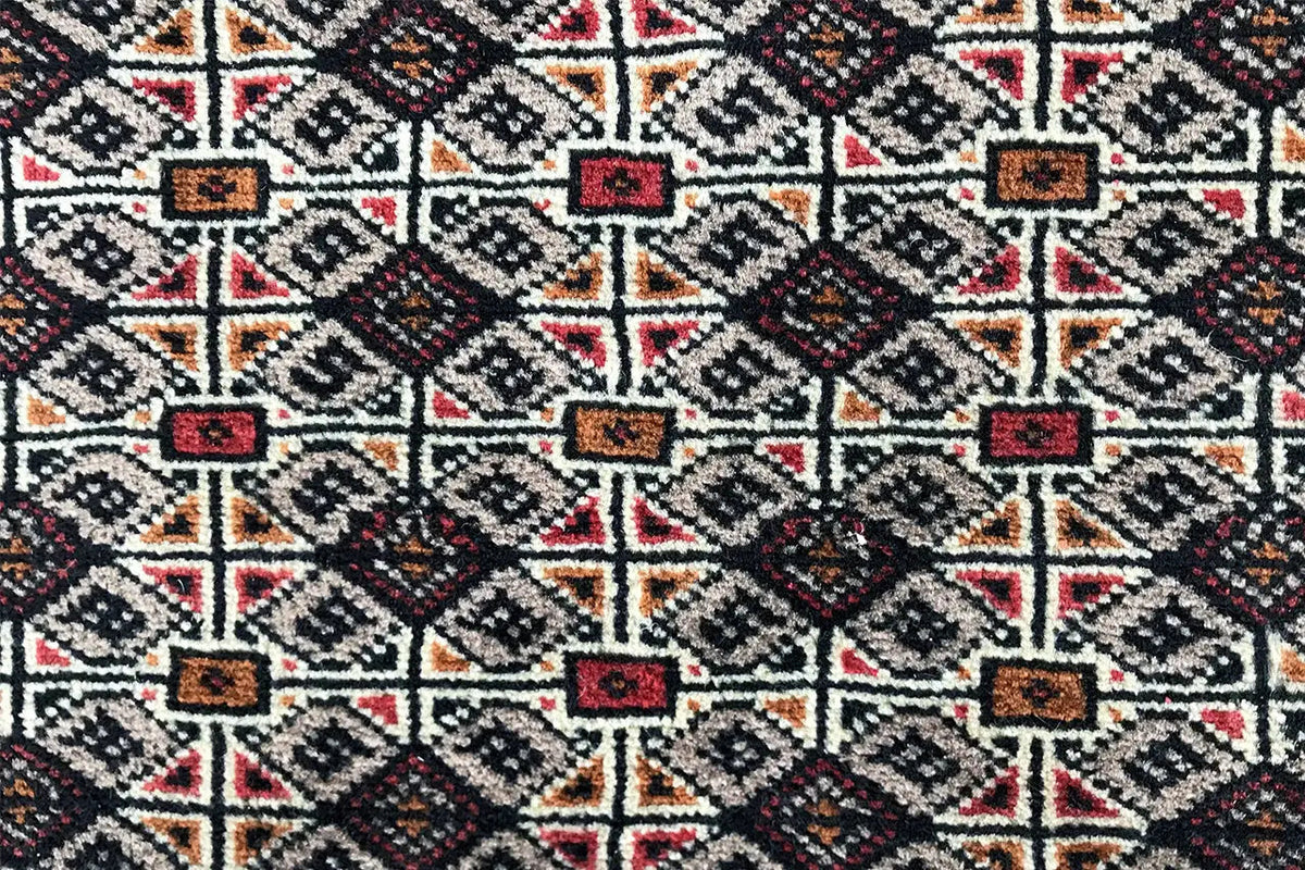 Turkmen Poshti rug, dense geometric pattern with red accents, covering the entire surface