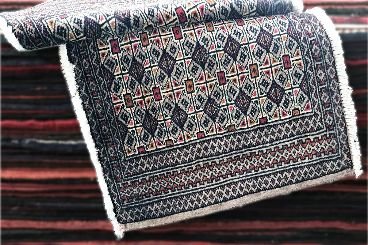 Turkmen Poshti rug, folded rectangularly, dark with red and beige ornaments