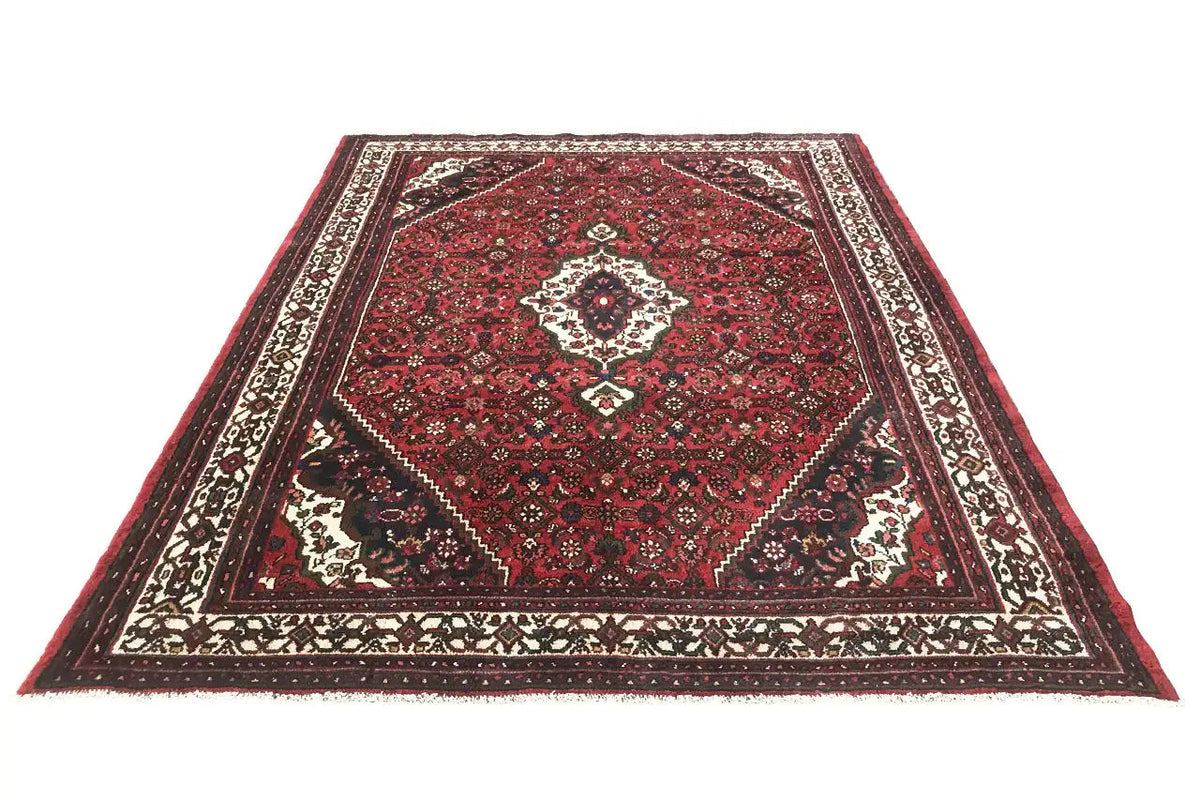 Oriental rug with a red pattern and border in black, white, and cream
