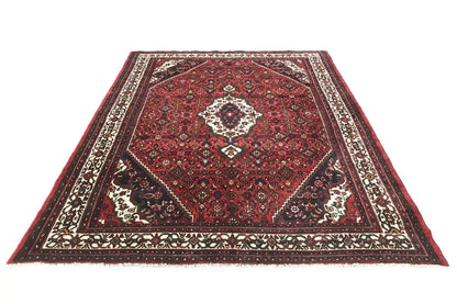 Oriental rug with a red pattern and border in black, white, and cream