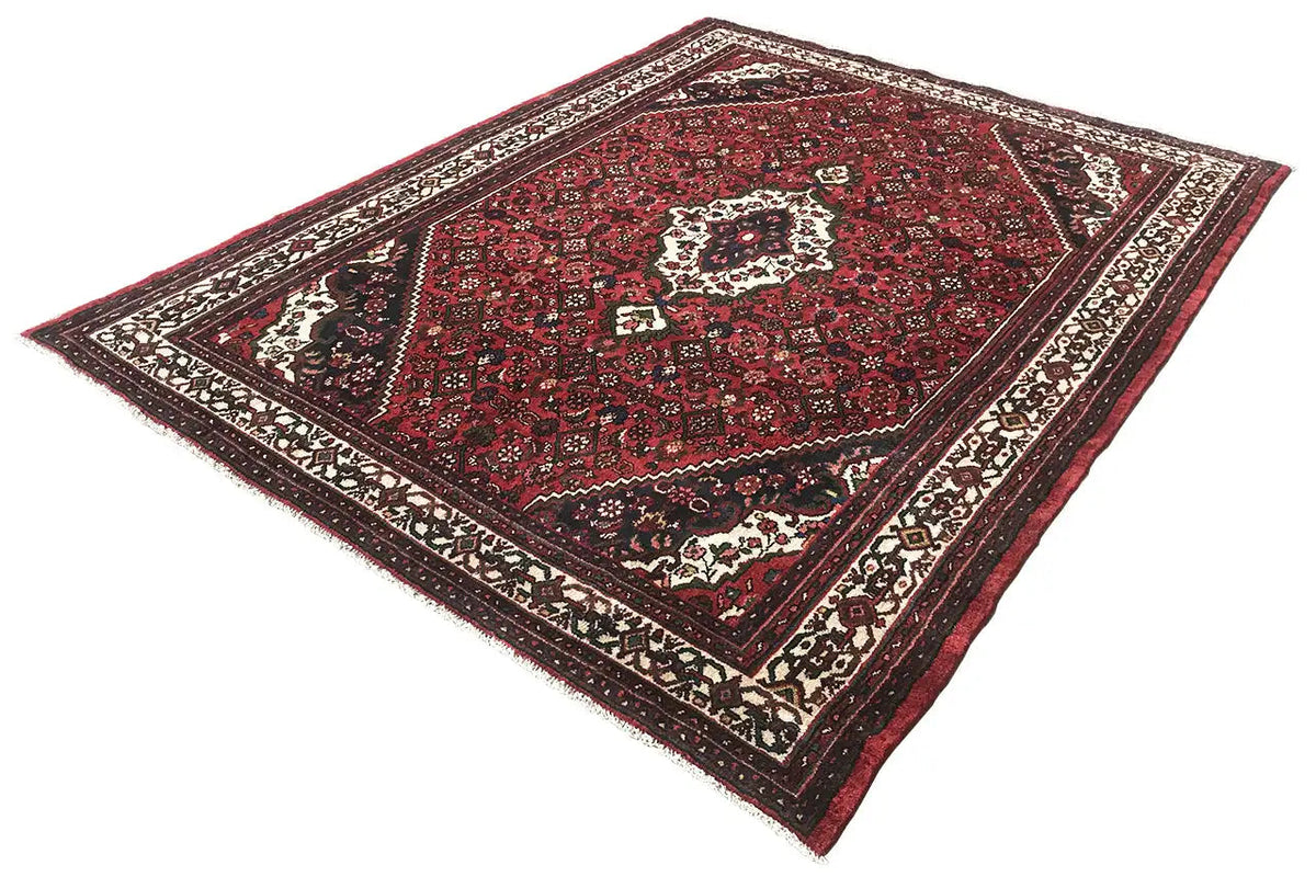 Red carpet with a central medallion and surrounding ornamental borders, laid diagonally