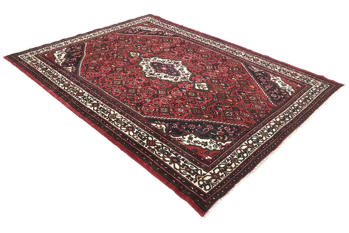 Rug with a red central field, white medallion, and dark border pattern