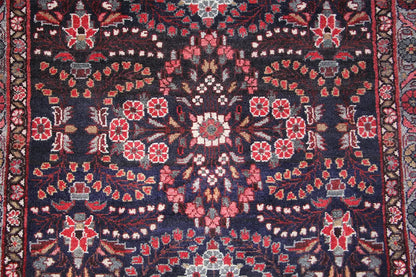 Hamadan runner close-up: blue pattern with red flowers and white decorative elements