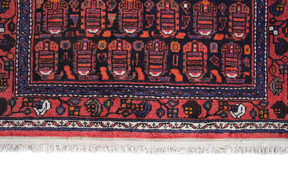 Hamadan runner with a detailed pattern in blue and red, a border, and fringes along the edge
