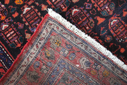 Corner of a Hamadan runner with a gray central field, red-and-blue ornaments, and fringes