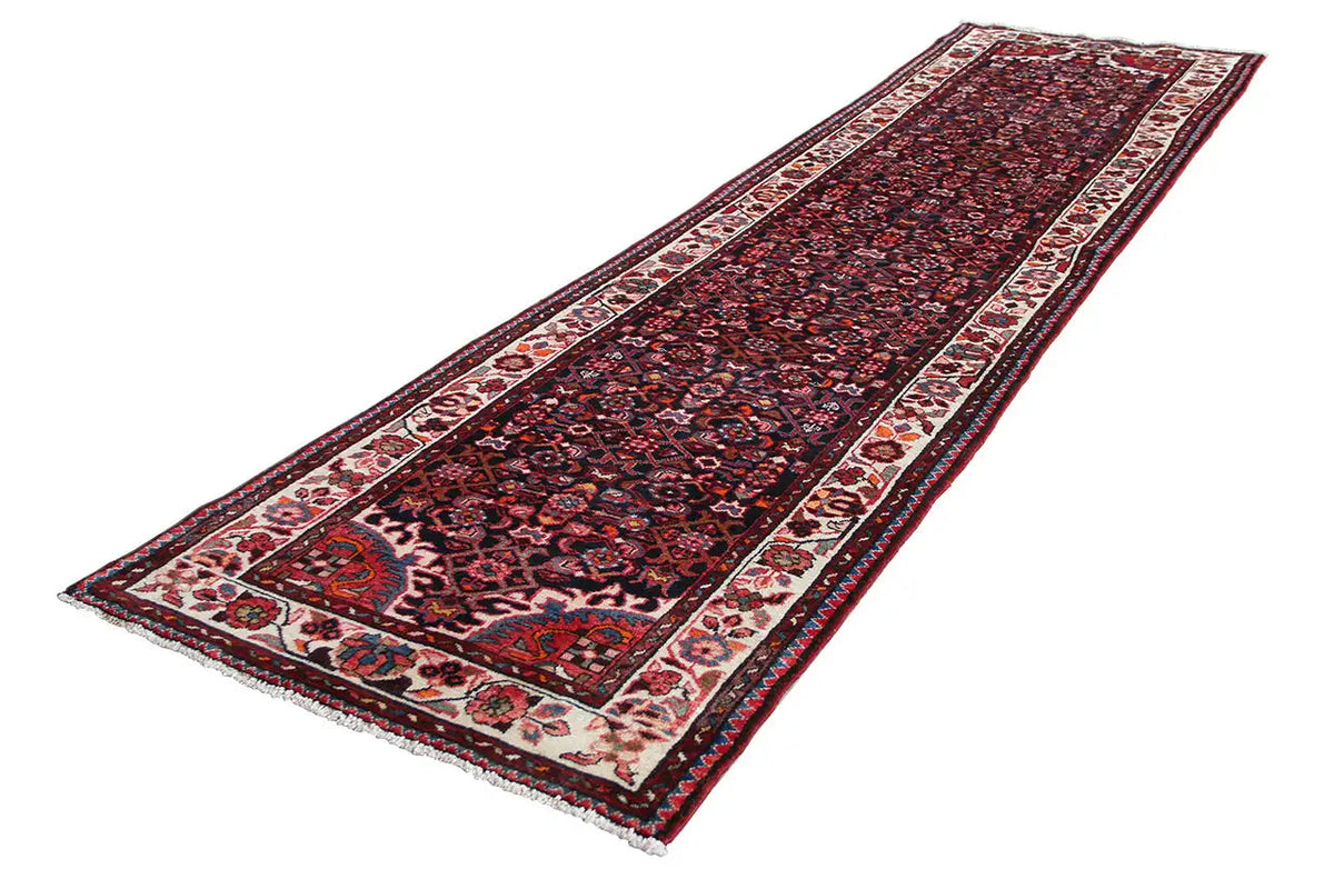Oriental rug runner with dark red, dark blue patterns and surrounding borders