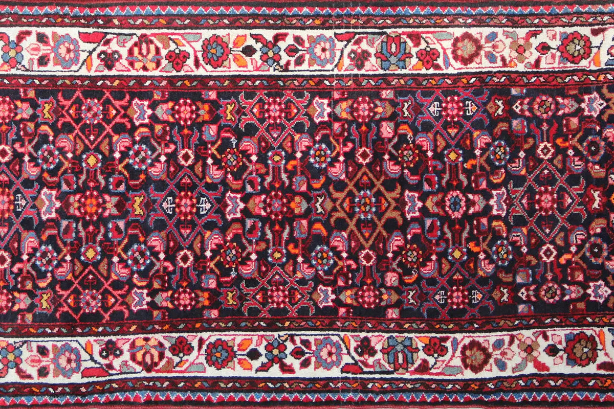 Detailed view: runner with a dark blue-red pattern, delicate ornaments and borders