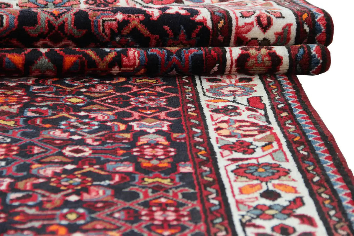 Folded runner with a dark red ornamental pattern and a wide central border