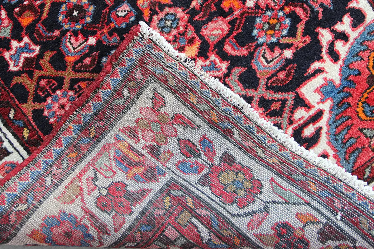 Selvedge detail: gray-blue area with colorful ornaments and a frayed edge