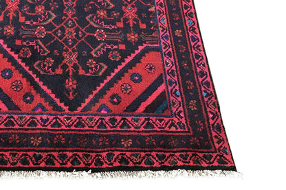 Oriental rug runner: close-up of the border with geometric motifs in pink and blue