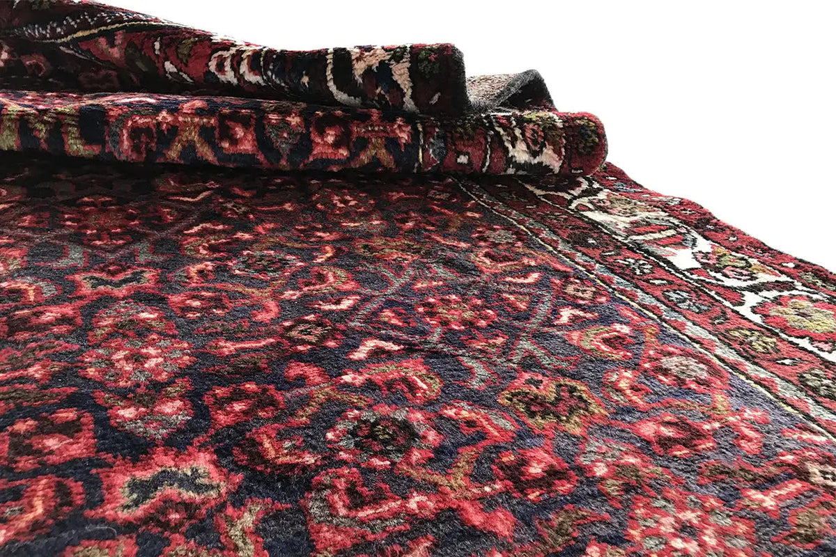 Runner rug with a slightly wavy look, red ornamental pattern, and border all around