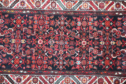 Detail view of the Oriental rug pattern: dark red, blue, and ornaments