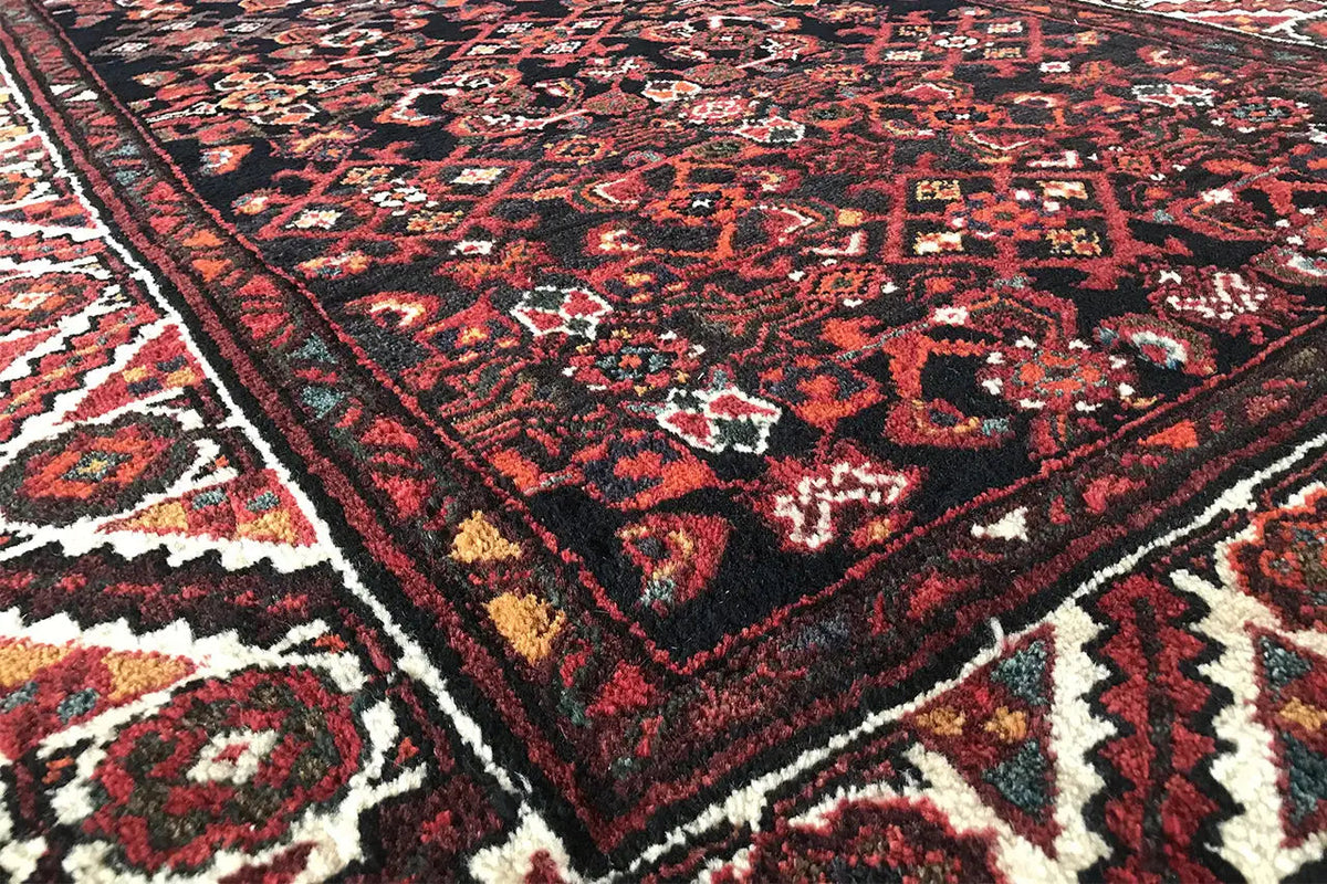 Close-up of the carpet pattern: dark red, black, and beige accents