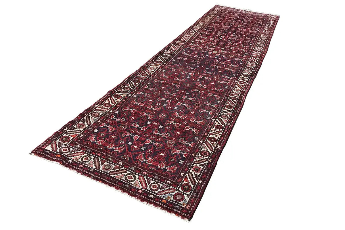 Red patterned runner with floral ornaments and a wide border stripe