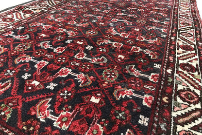 Close-up: dark red runner with finely crafted ornaments and decorative bands