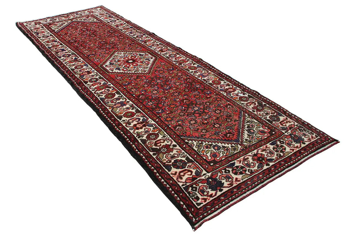 Red runner with geometric medallion, multicolored border and fringes