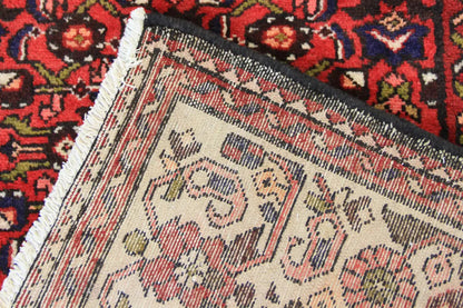 Edge detail: red table runner with a patterned hem and woven-in lines
