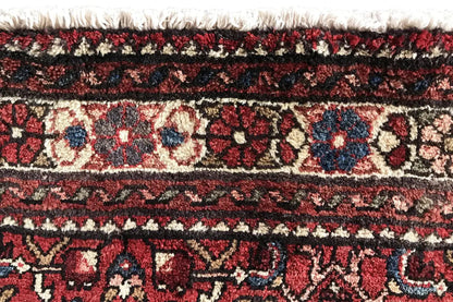 Hamadan runner detail: fringes and dense pile with red, beige, and dark blue patterns