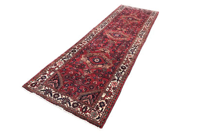 Long Oriental-style runner, red with decorative border and multicolored medallion motifs